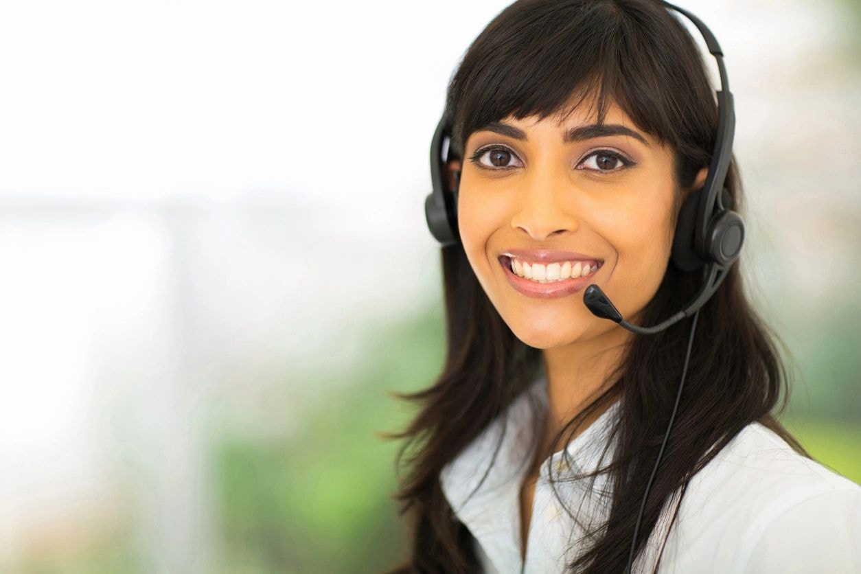 Smiling professional consultant wearing a telephone headset
